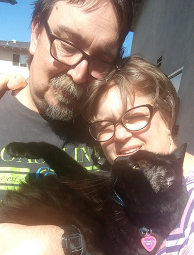 This image is Jenn Ardinger, her husband, Charles, and their cat.